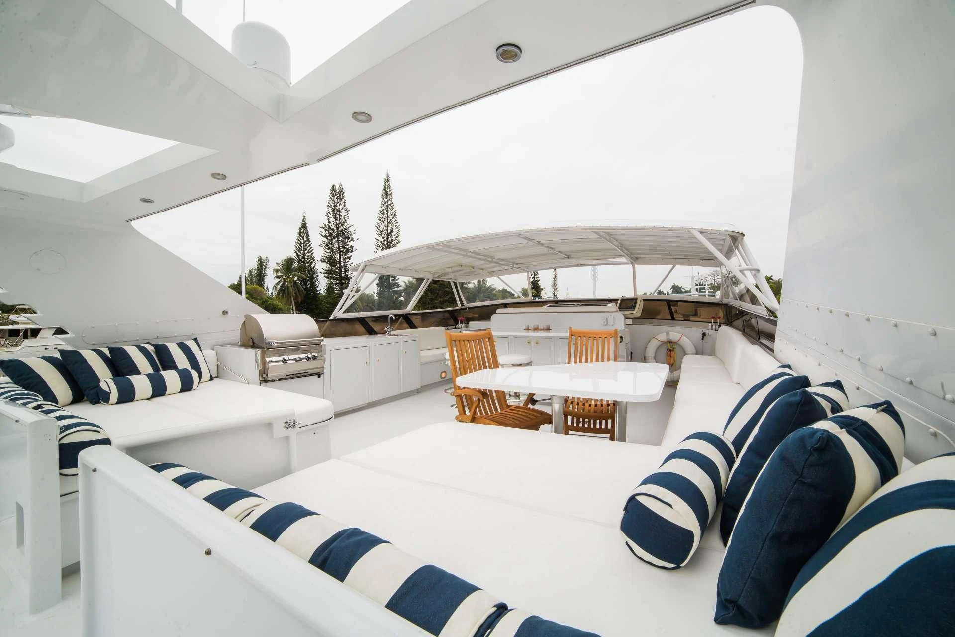 a room with a large white tent and a couch and a table with chairs and a large white aboard LADY LEX Yacht for Sale