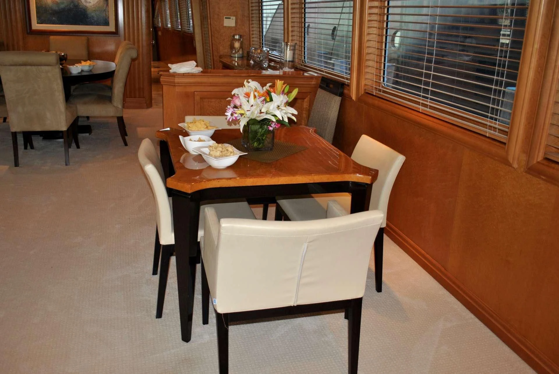 a table with chairs around it aboard LADY LEX Yacht for Sale