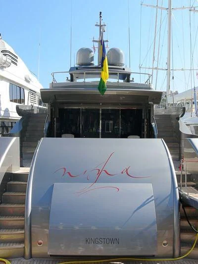 a boat with a flag on the front aboard NINA J Yacht for Sale