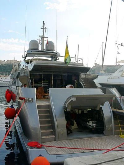 a boat with a flag on the deck aboard NINA J Yacht for Sale