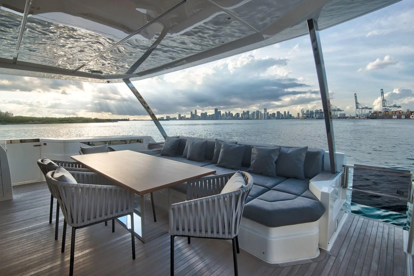 a room with a couch and a table and chairs aboard CIAO II Yacht for Sale