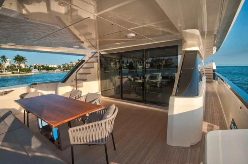 a table and chairs on a deck aboard CIAO II Yacht for Sale