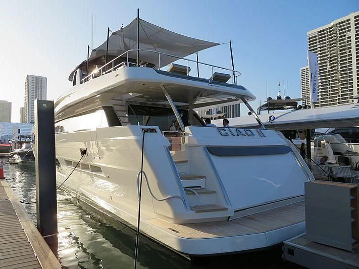 a white boat docked at a pier aboard CIAO II Yacht for Sale
