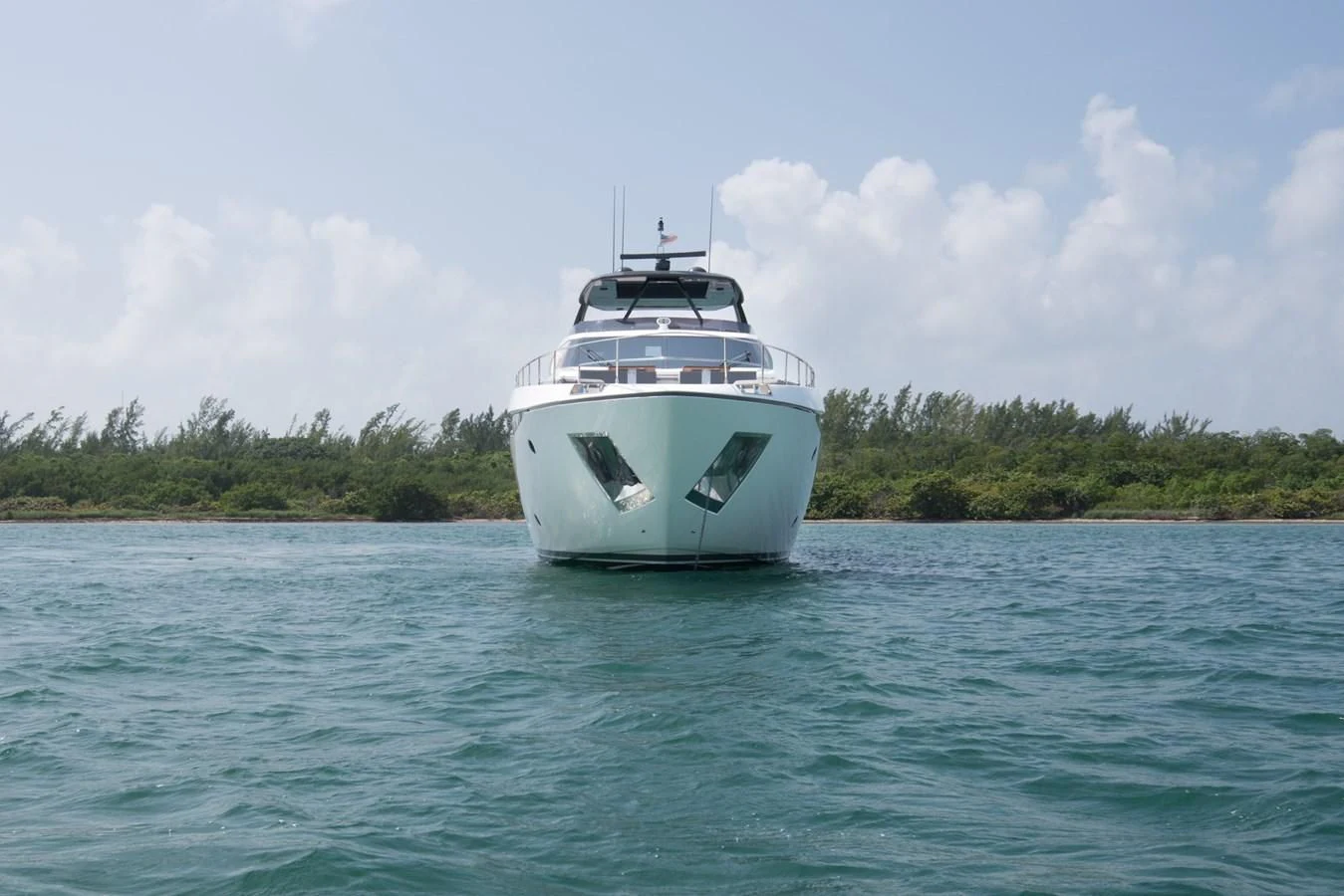 a white boat on the water aboard CIAO II Yacht for Sale