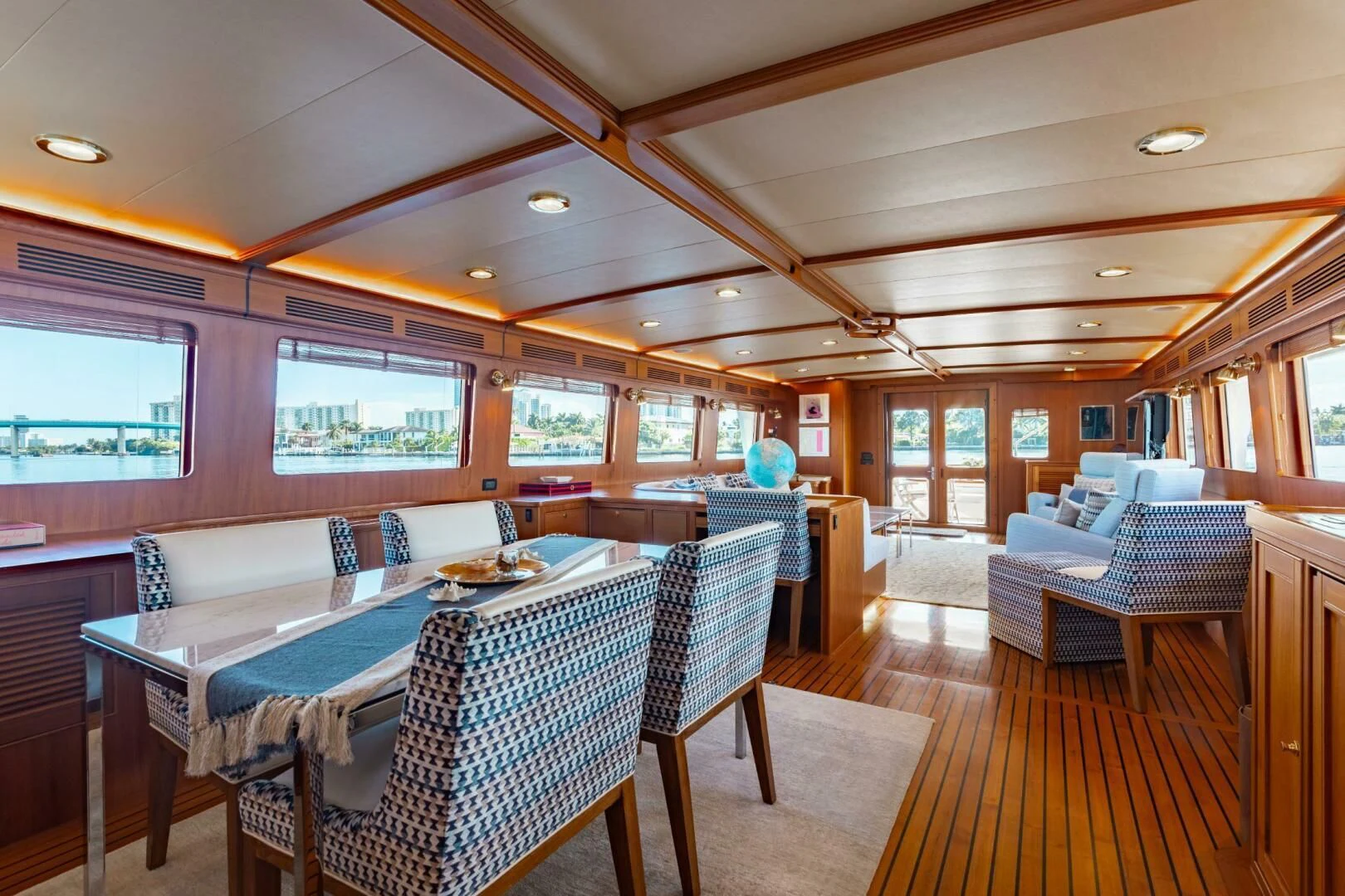 a large room with a table and chairs aboard VIRGINIA SEA Yacht for Sale