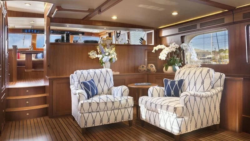 a living room with a white couch and a wood wall aboard VIRGINIA SEA Yacht for Sale