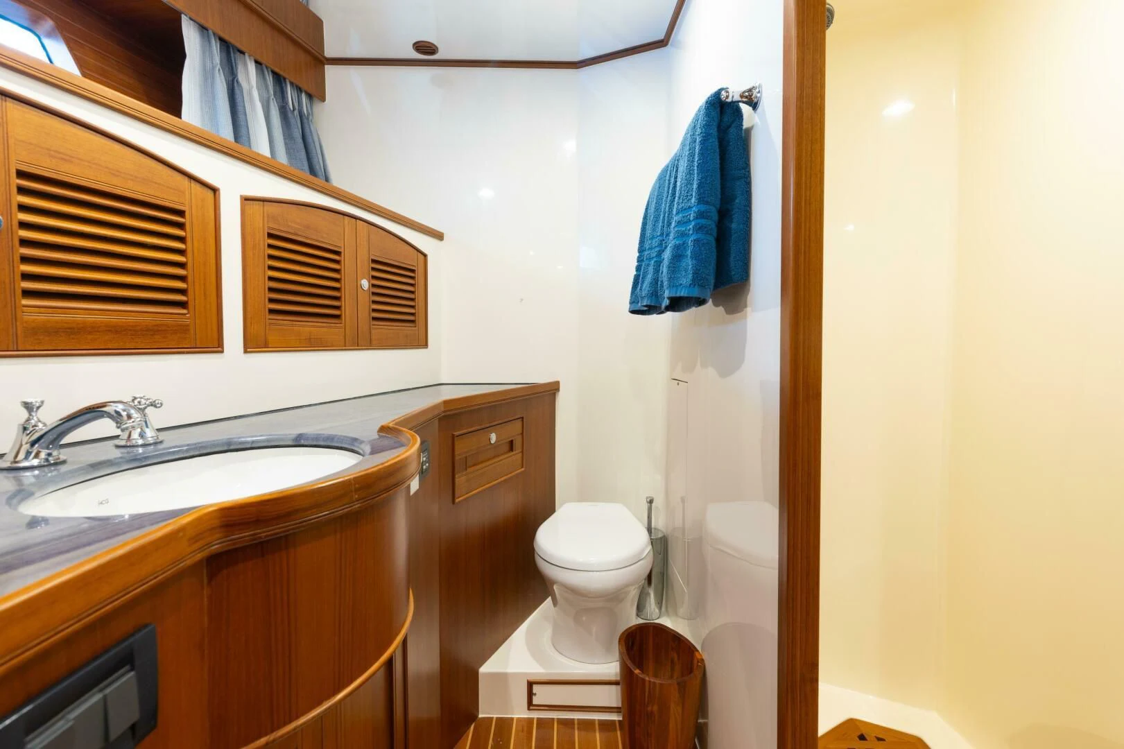 a bathroom with a sink toilet and a mirror aboard VIRGINIA SEA Yacht for Sale