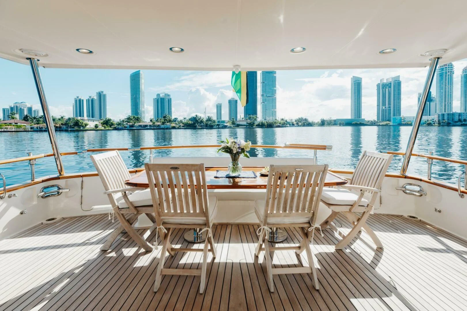 a table and chairs on a deck overlooking a city aboard VIRGINIA SEA Yacht for Sale