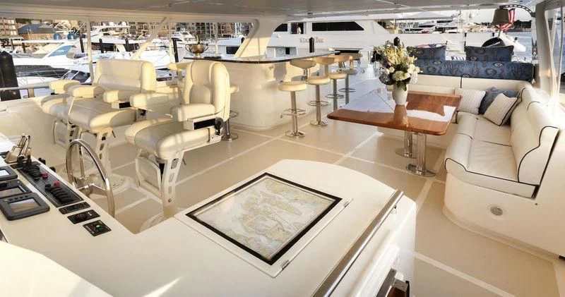 a room with a couch and a table with chairs aboard VIRGINIA SEA Yacht for Sale