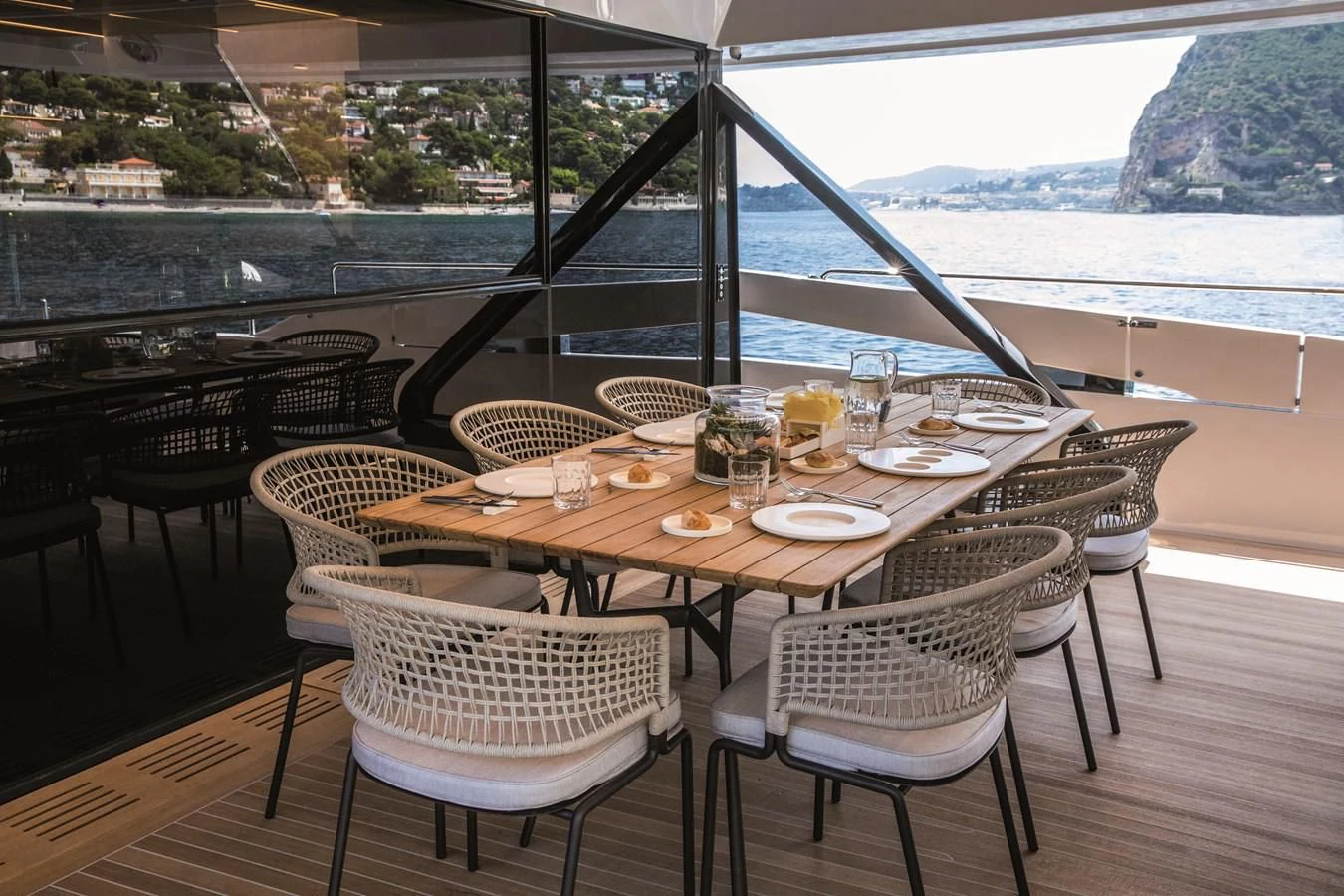 a table set with glasses and plates aboard SONEY Yacht for Sale
