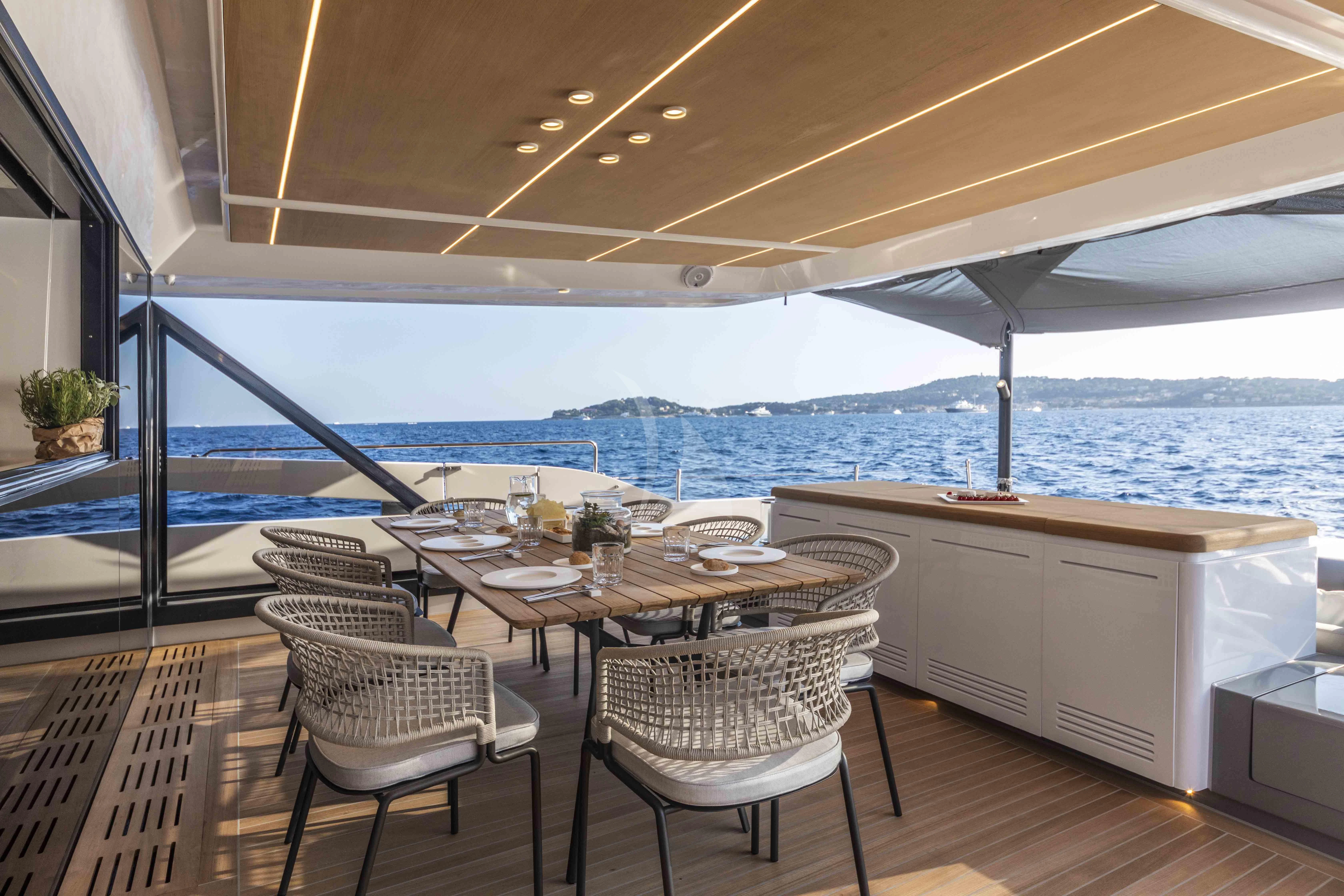 a table and chairs on a deck aboard SONEY Yacht for Sale