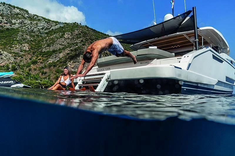 a man jumping into a boat aboard SONEY Yacht for Sale