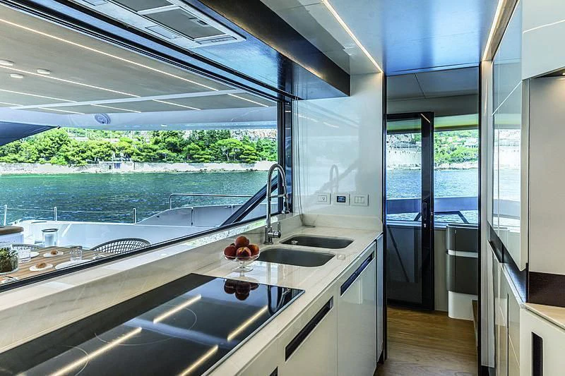 a kitchen with a view of the water and trees aboard SONEY Yacht for Sale