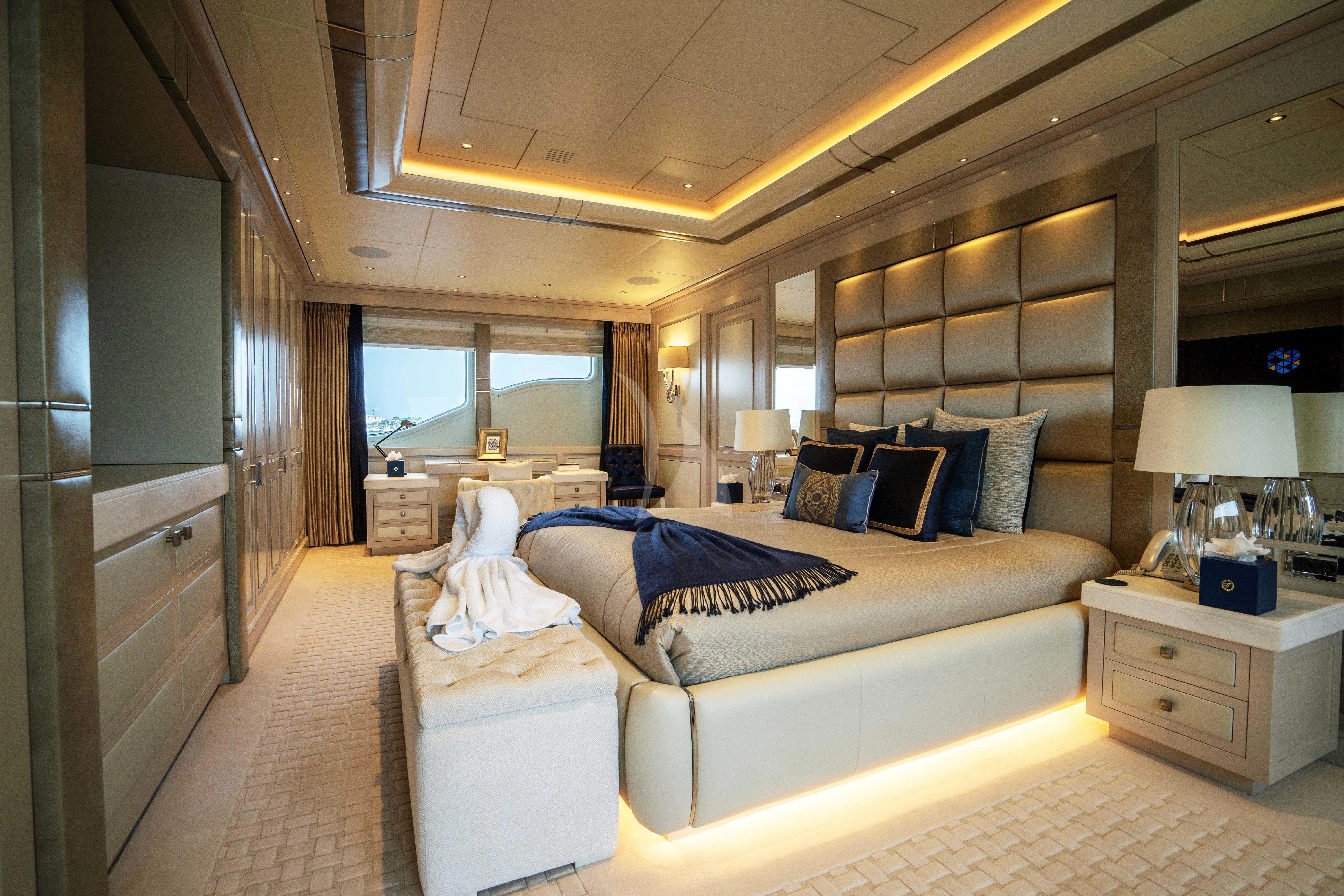 a room with a bed and a desk aboard TACANUYA Yacht for Charter