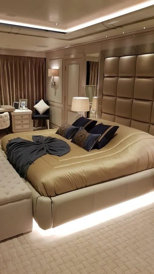 a bed with a blue blanket aboard TACANUYA Yacht for Charter
