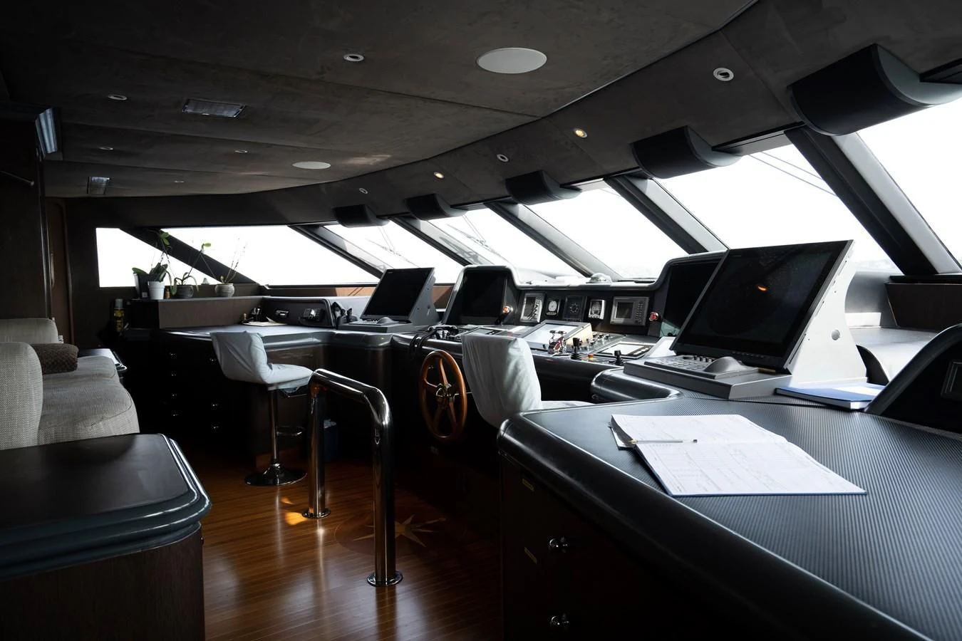 a room with a laptop and chairs aboard TACANUYA Yacht for Charter