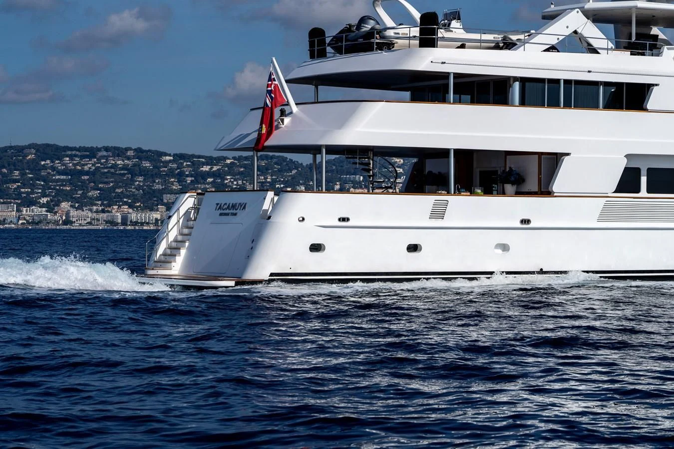 a large white boat on the water aboard TACANUYA Yacht for Charter
