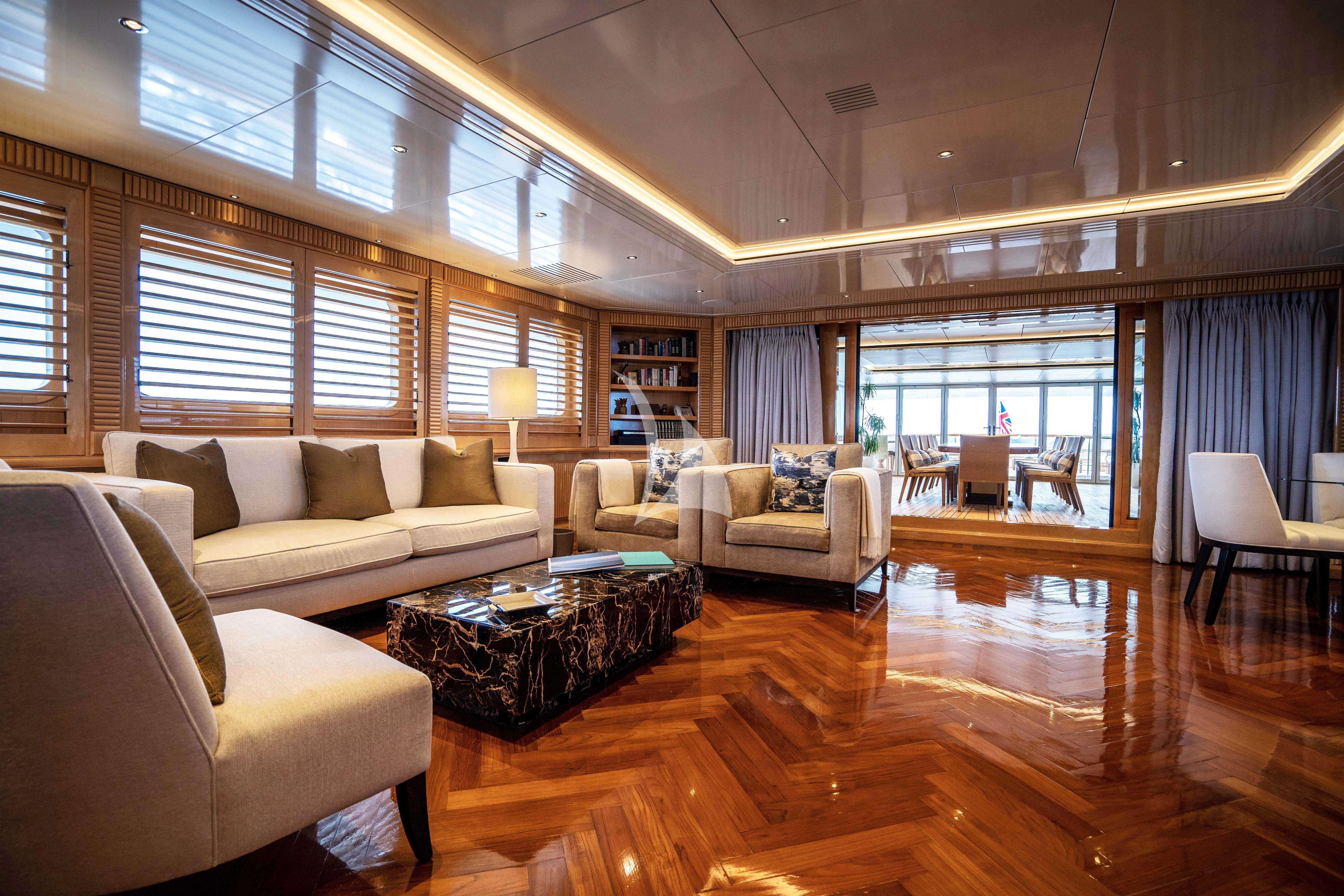 a living room with a wood floor aboard TACANUYA Yacht for Charter
