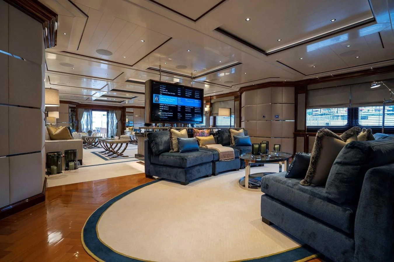 a living room with a large screen aboard TACANUYA Yacht for Charter