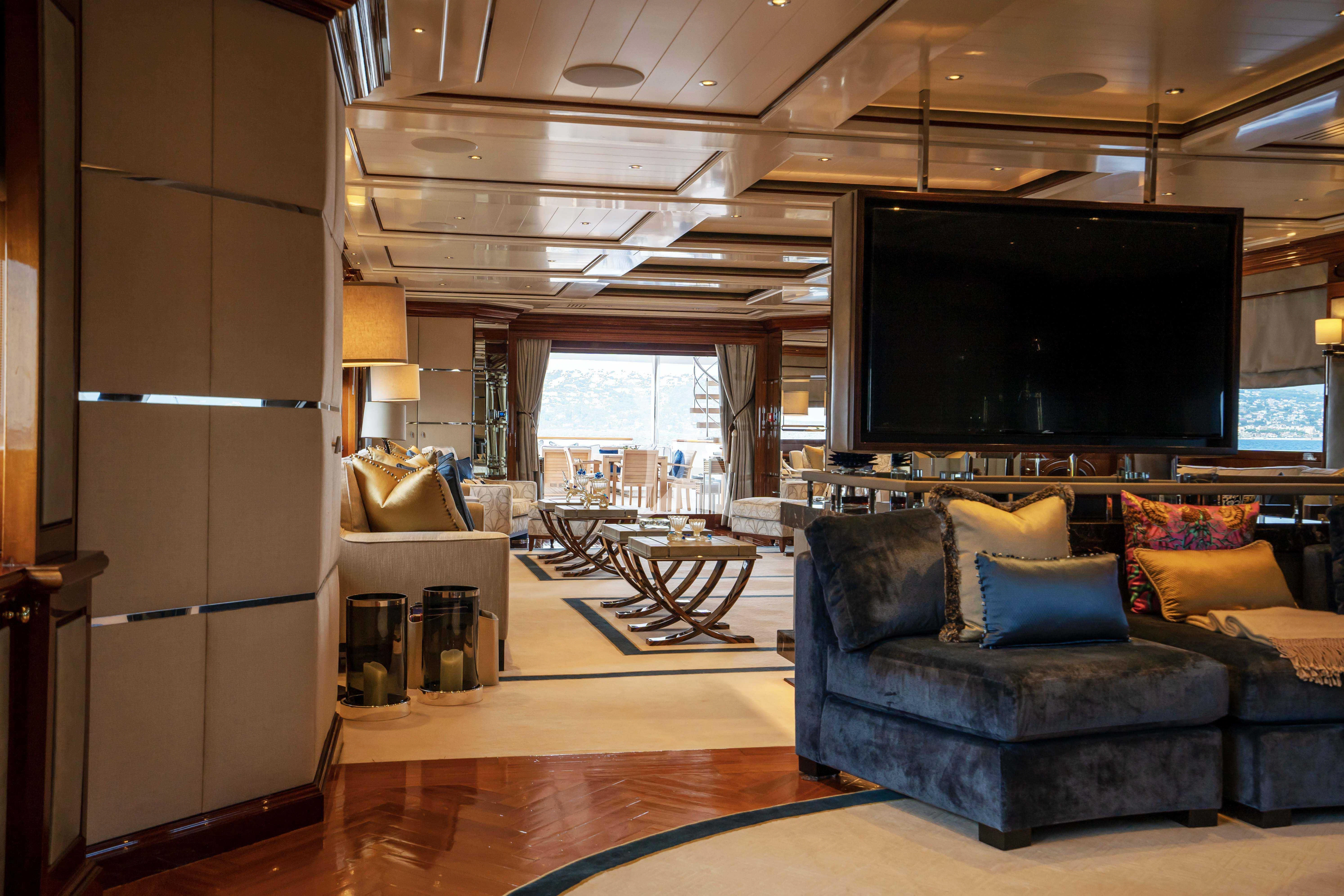 a living room with a large tv aboard TACANUYA Yacht for Charter