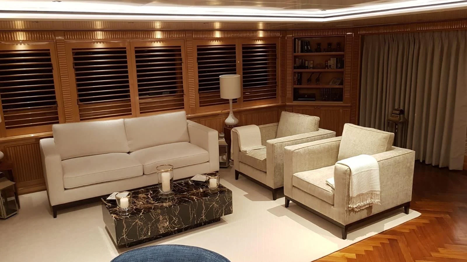 a living room with a couch and a coffee table aboard TACANUYA Yacht for Charter