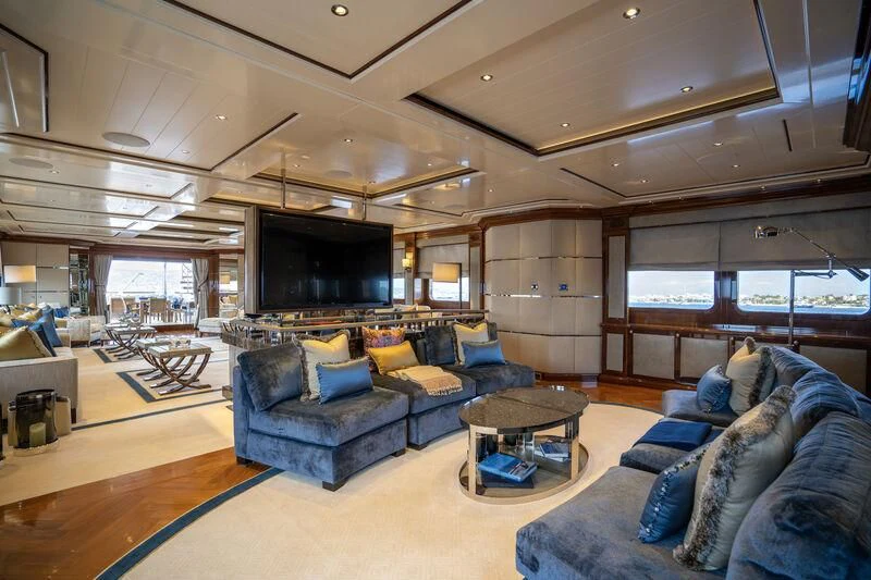 a living room with a large screen aboard TACANUYA Yacht for Charter