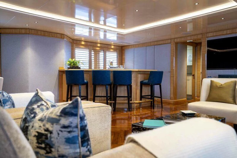 a room with couches and chairs aboard TACANUYA Yacht for Charter