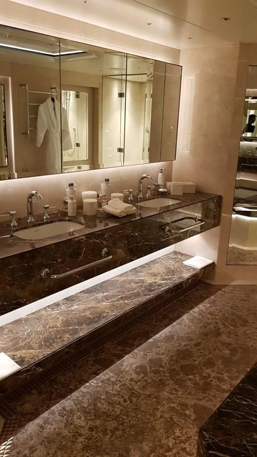 a bathroom with a large marble counter top aboard TACANUYA Yacht for Charter