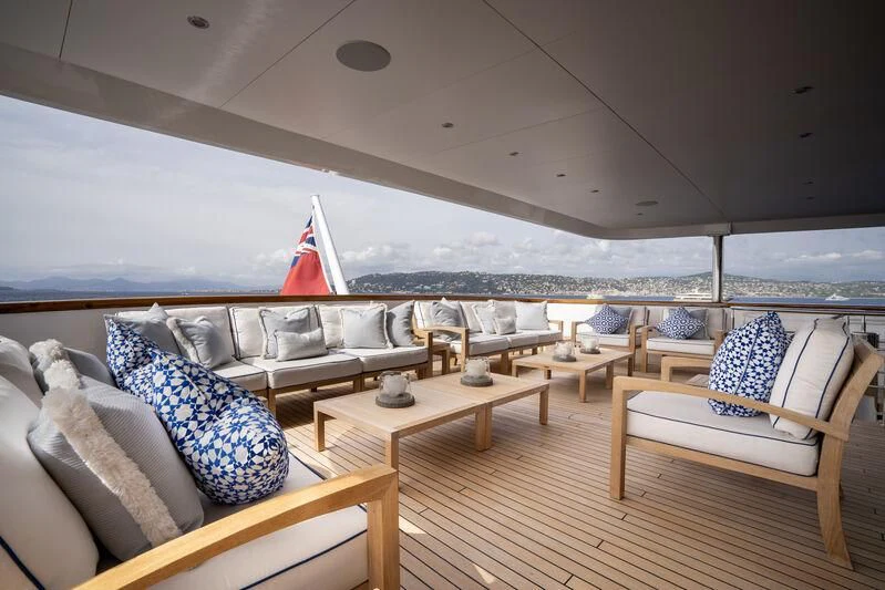 a room with a view of the ocean and a large boat aboard TACANUYA Yacht for Charter