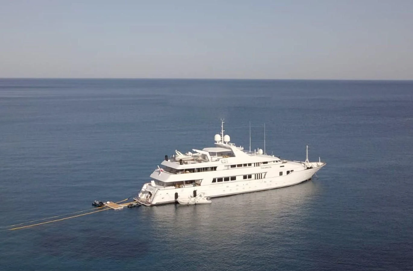 a large white ship in the water aboard TACANUYA Yacht for Charter