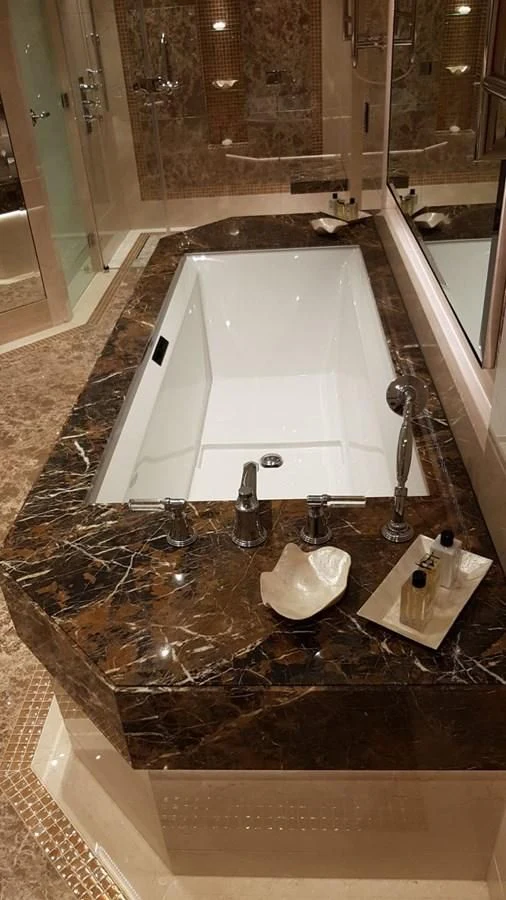 a bathroom with a bathtub and sink aboard TACANUYA Yacht for Charter