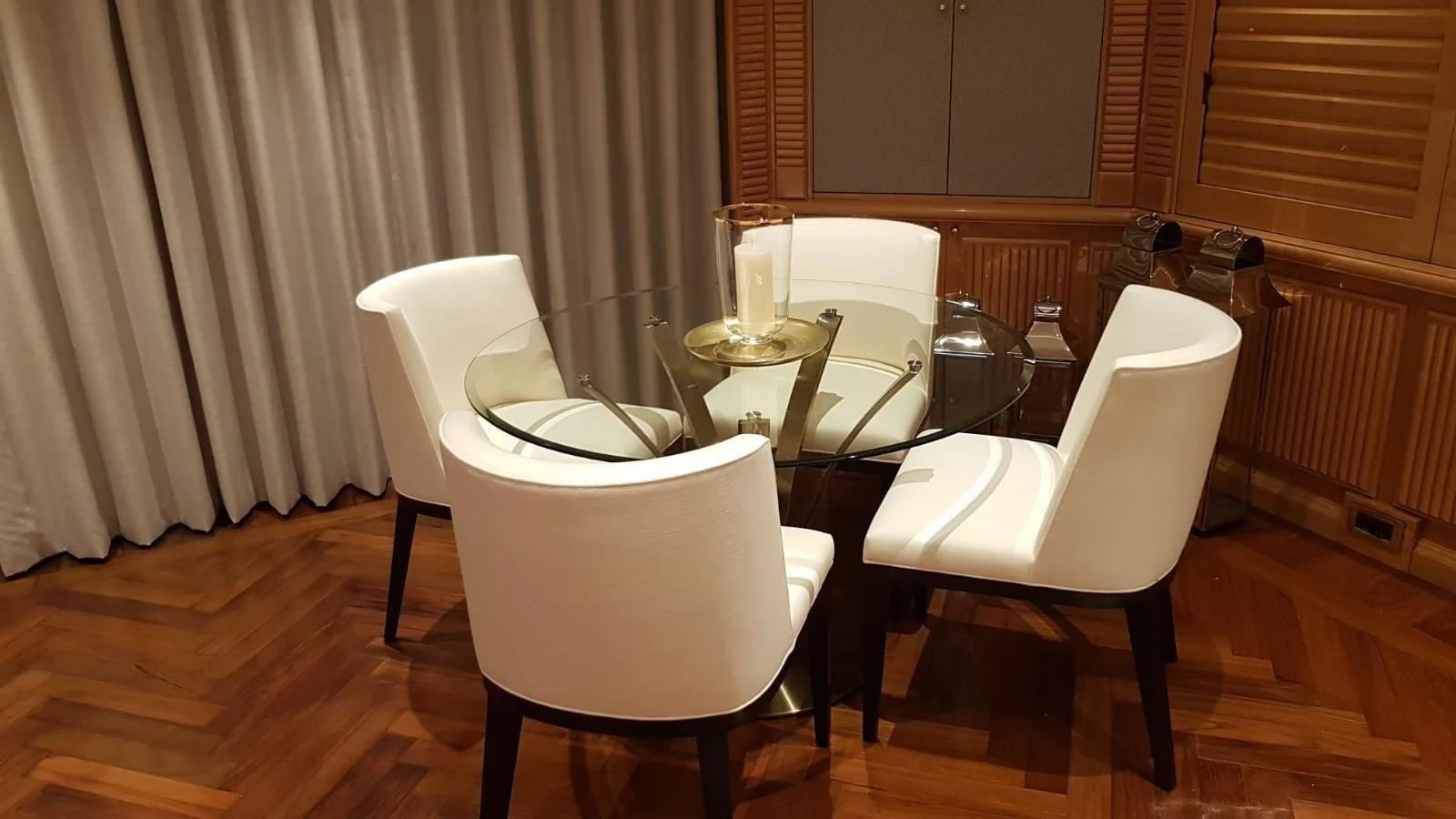 a couple of white chairs next to a table with a glass on it aboard TACANUYA Yacht for Charter