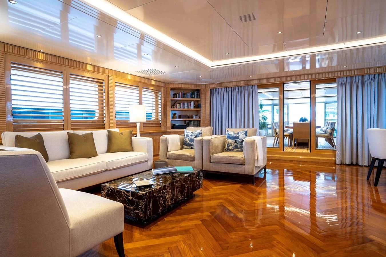 a living room with a large window aboard TACANUYA Yacht for Charter