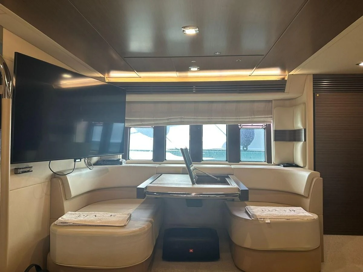 a room with a tv and a couch aboard AZIMUT 64 FLY 2014 Yacht for Sale