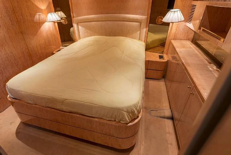 a bed with a white cover aboard HERMES Yacht for Sale