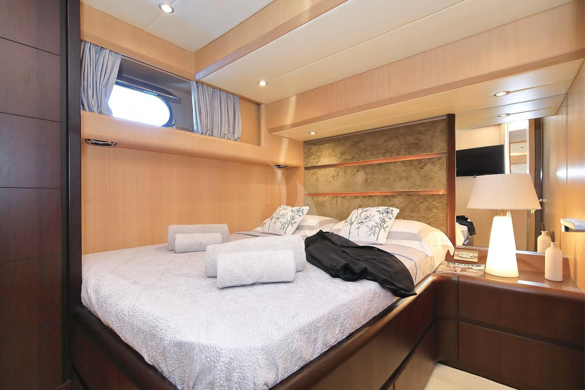 a bedroom with a bed and a lamp aboard HOPE I Yacht for Charter
