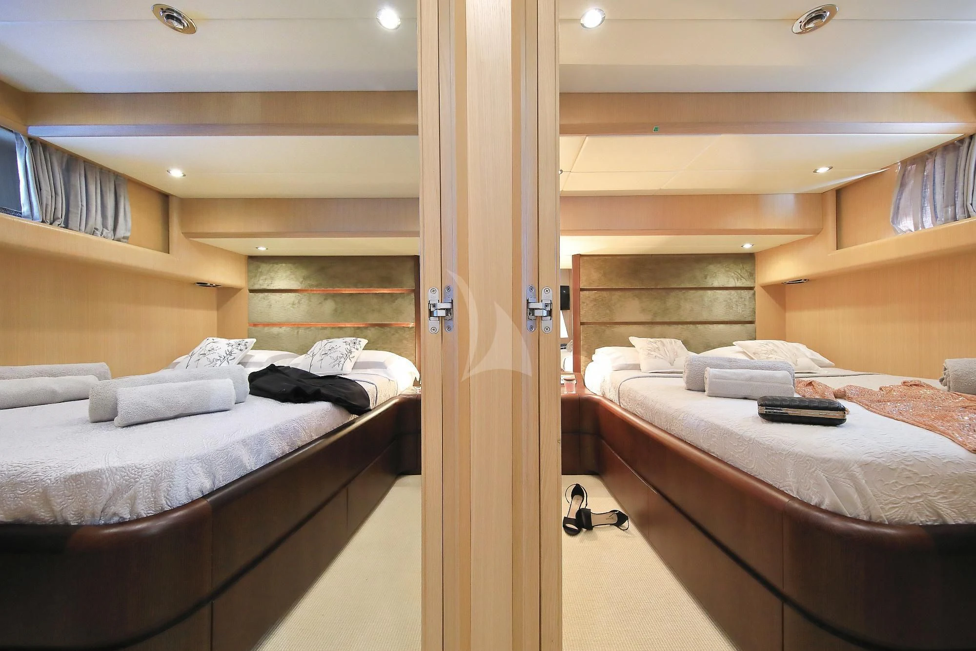 a room with beds and a closet aboard HOPE I Yacht for Charter