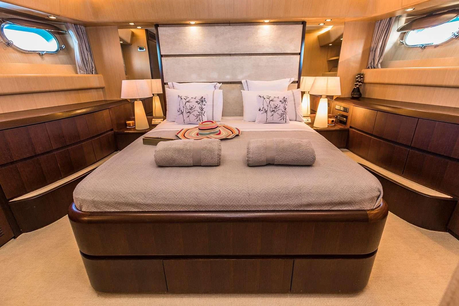a bed with a white comforter aboard HOPE I Yacht for Charter