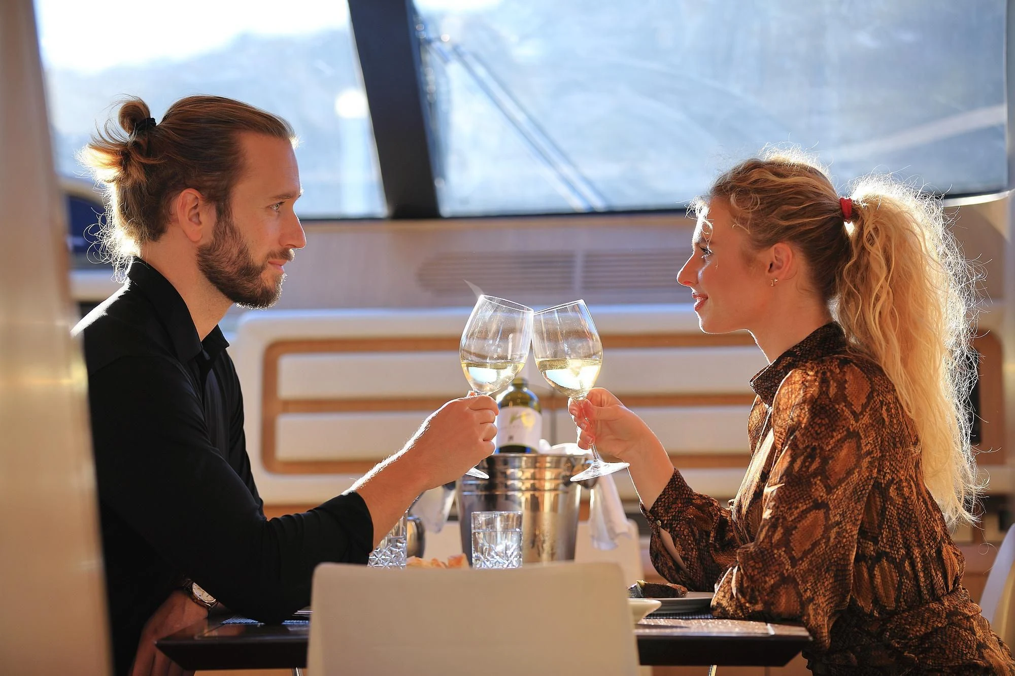 a man and a woman drinking wine aboard HOPE I Yacht for Charter