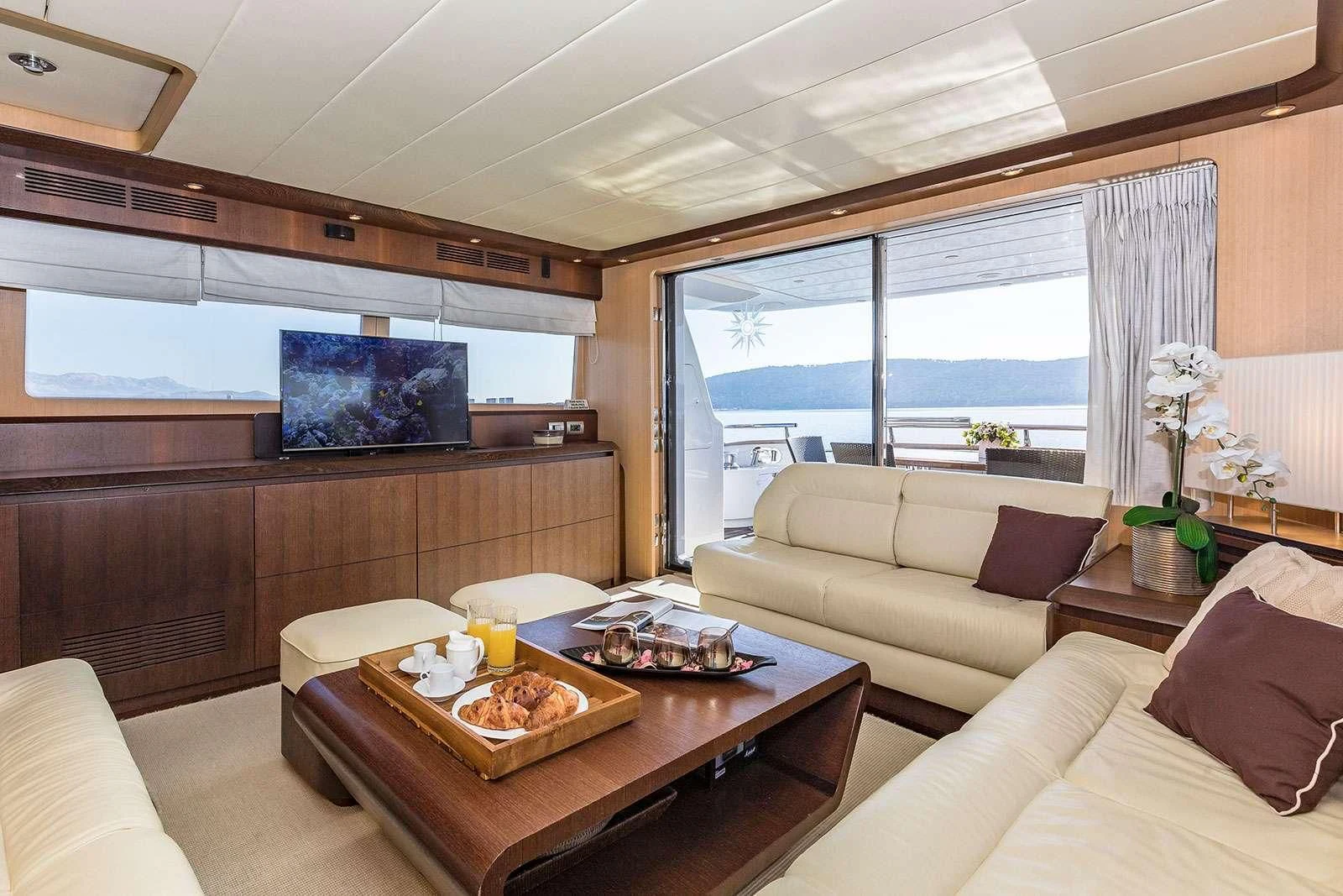 a living room with a couch and a coffee table aboard HOPE I Yacht for Charter