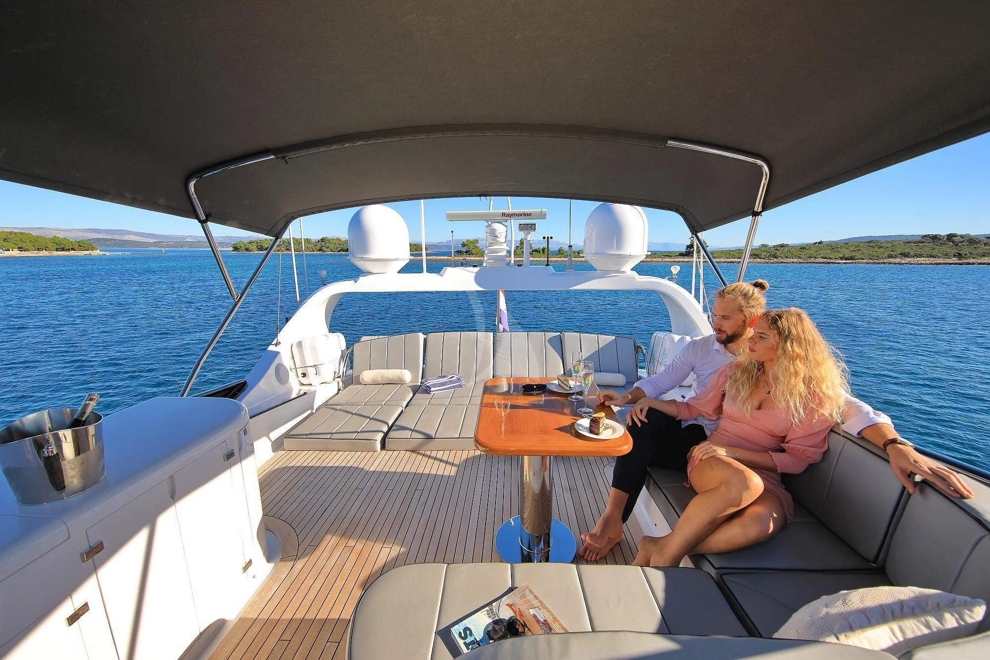 a man and woman sitting on a boat aboard HOPE I Yacht for Charter