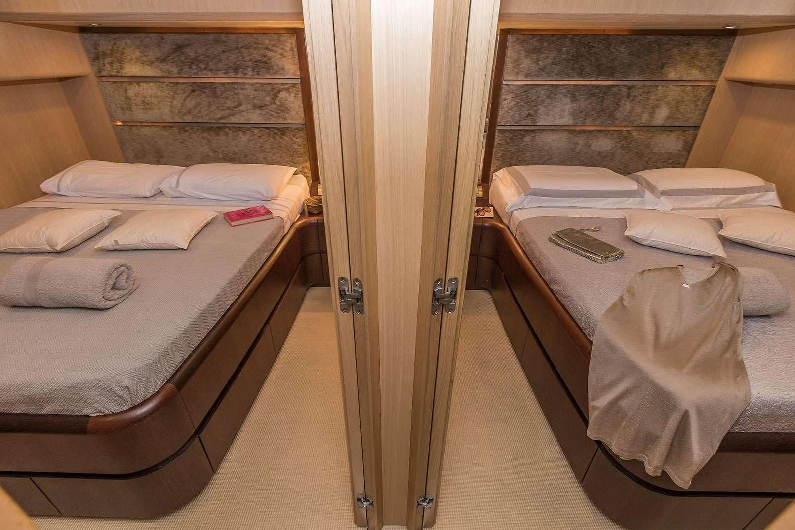 a room with beds and a closet aboard HOPE I Yacht for Charter