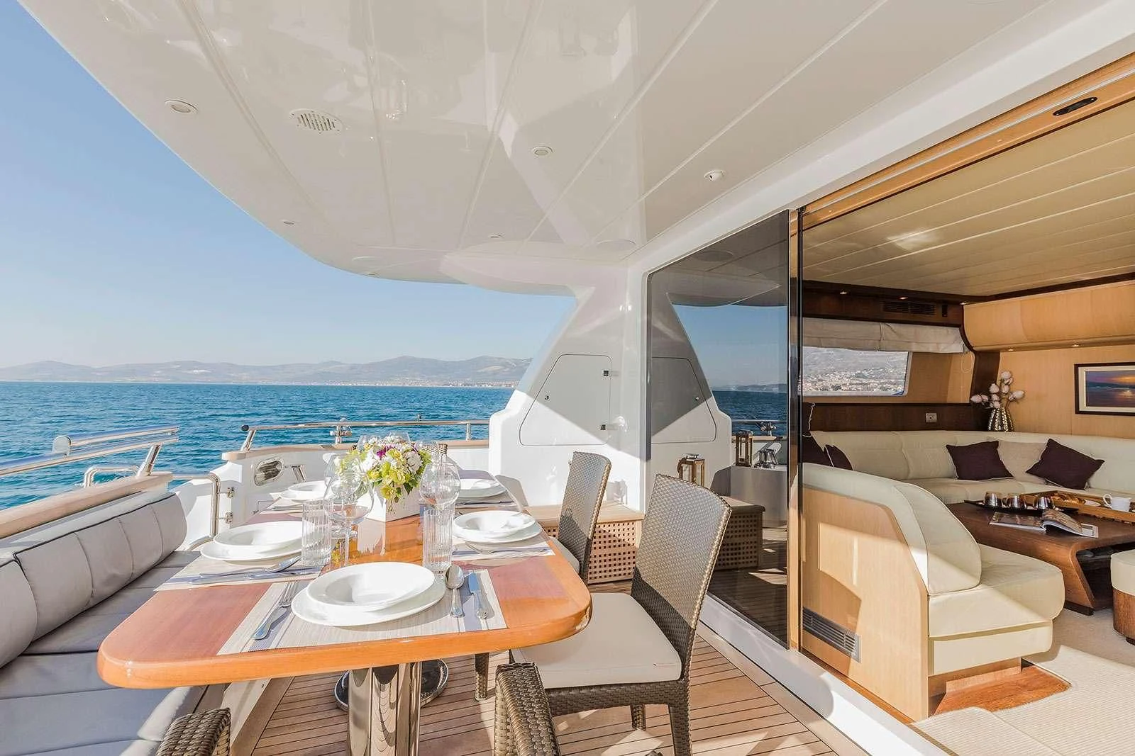 a room with a table chairs and a large body of water aboard HOPE I Yacht for Charter