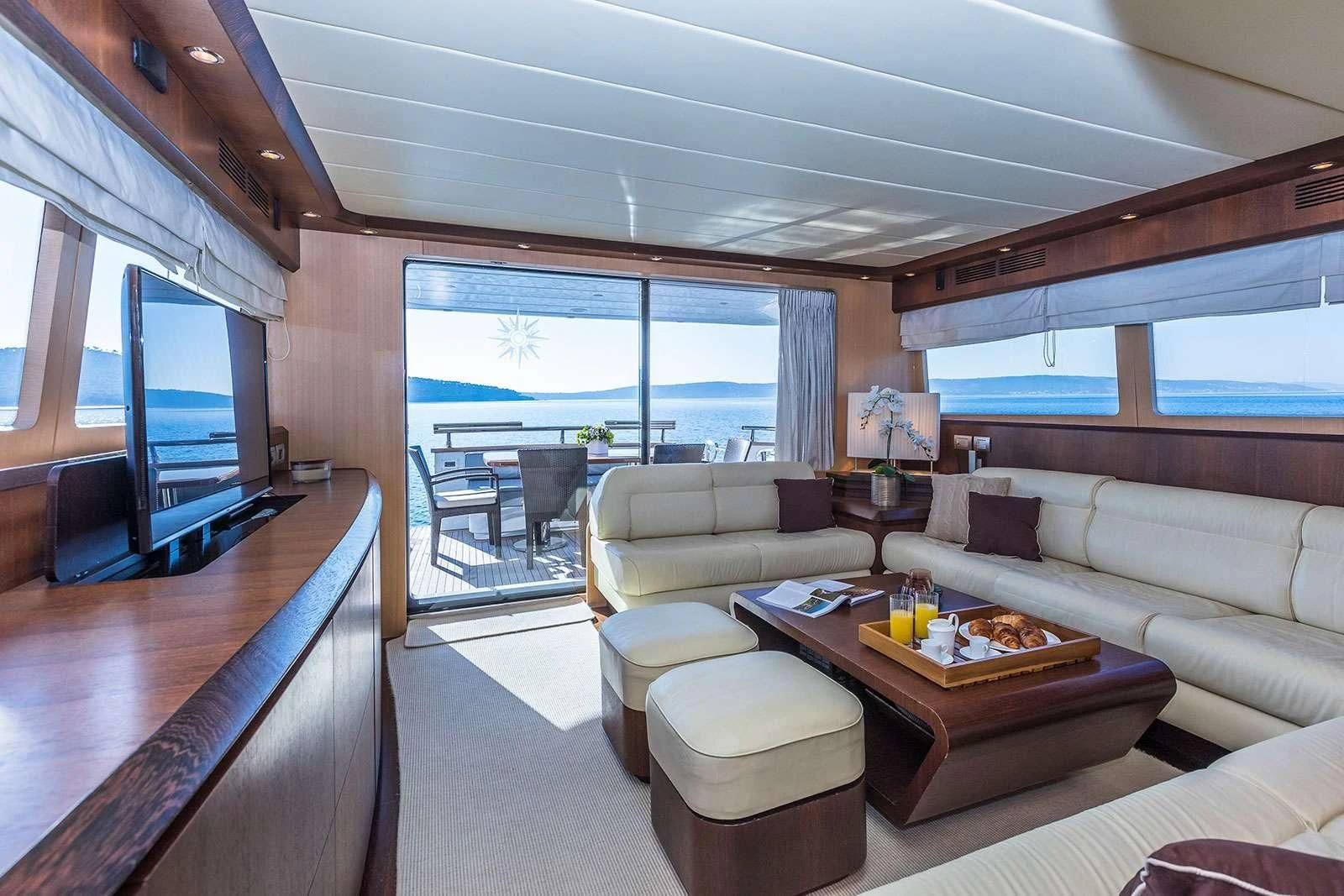 a living room with a large window aboard HOPE I Yacht for Charter