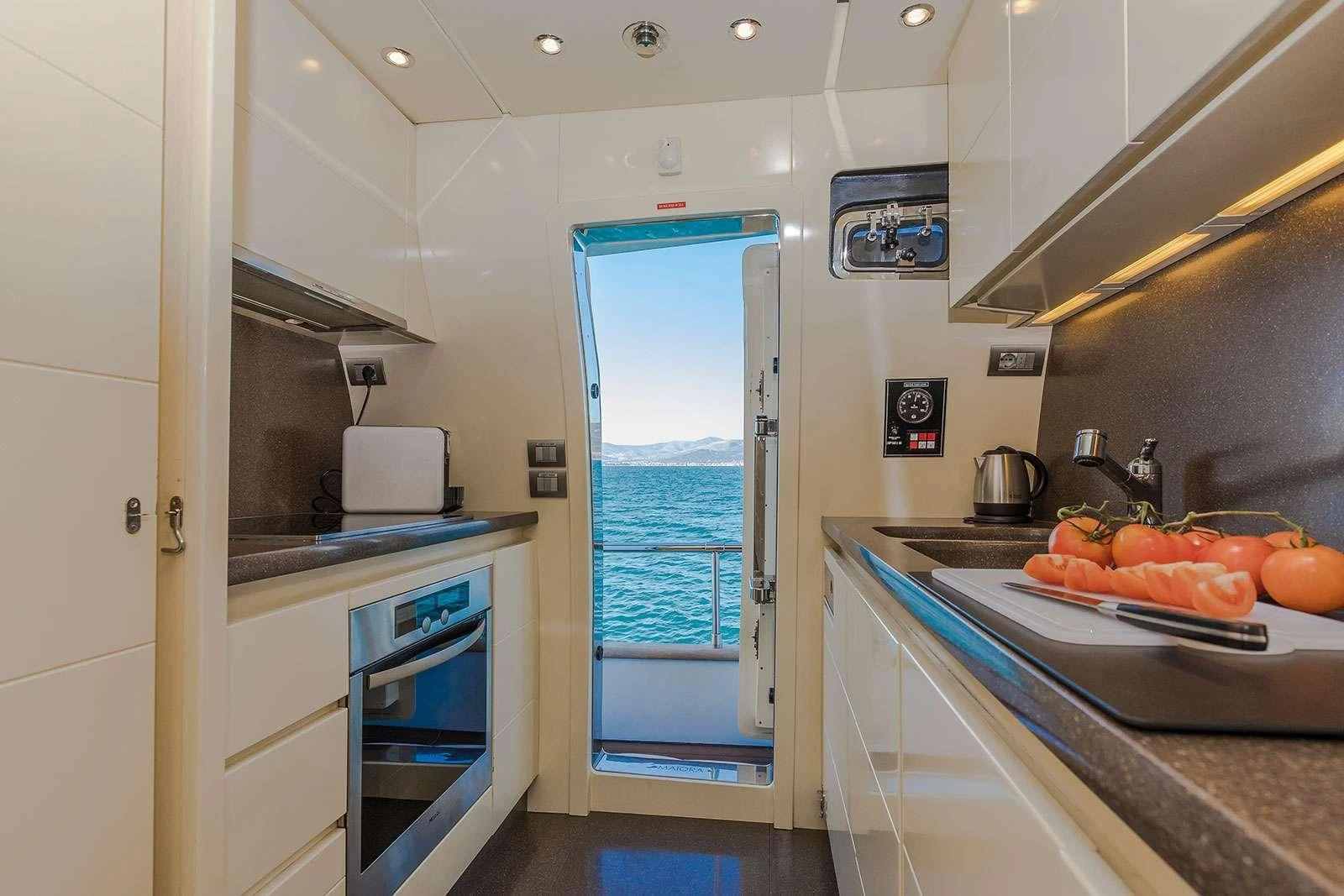 a kitchen with a sink and a window aboard HOPE I Yacht for Charter