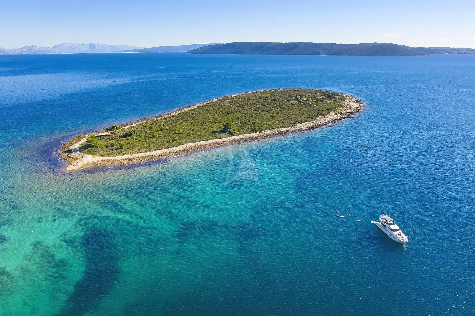 a boat sailing on the sea with Lady Elliot Island in the background aboard HOPE I Yacht for Charter