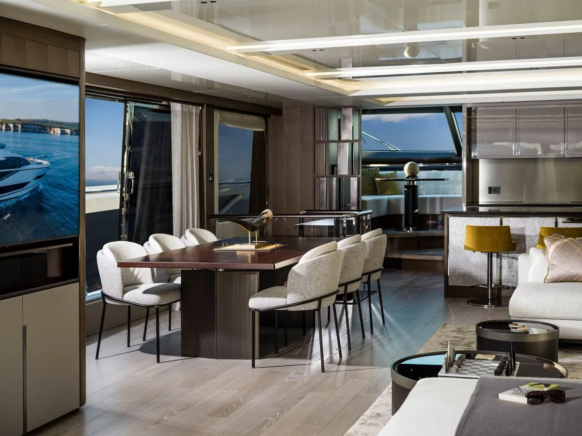 a room with a table chairs and a tv aboard 90 OCEAN Yacht for Sale