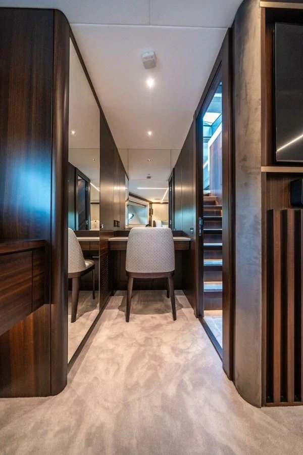 a room with a chair and a table and a door aboard 90 OCEAN Yacht for Sale