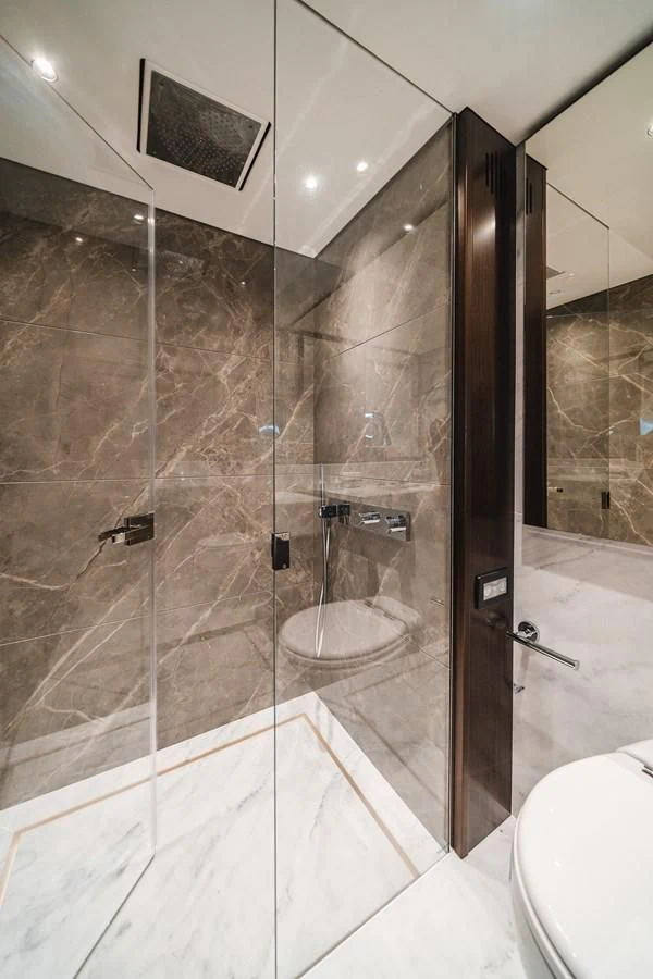 a bathroom with a glass shower aboard 90 OCEAN Yacht for Sale
