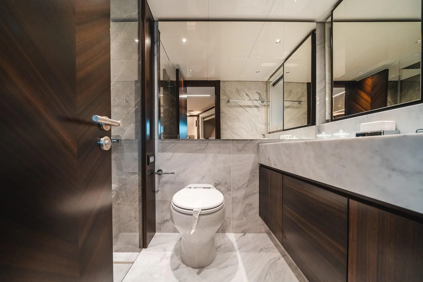 a bathroom with a toilet and a mirror aboard 90 OCEAN Yacht for Sale